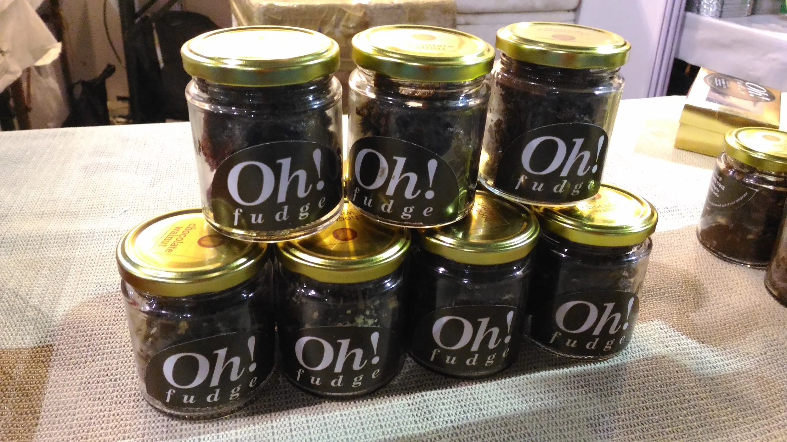 Golden lidded bottles of fudge.