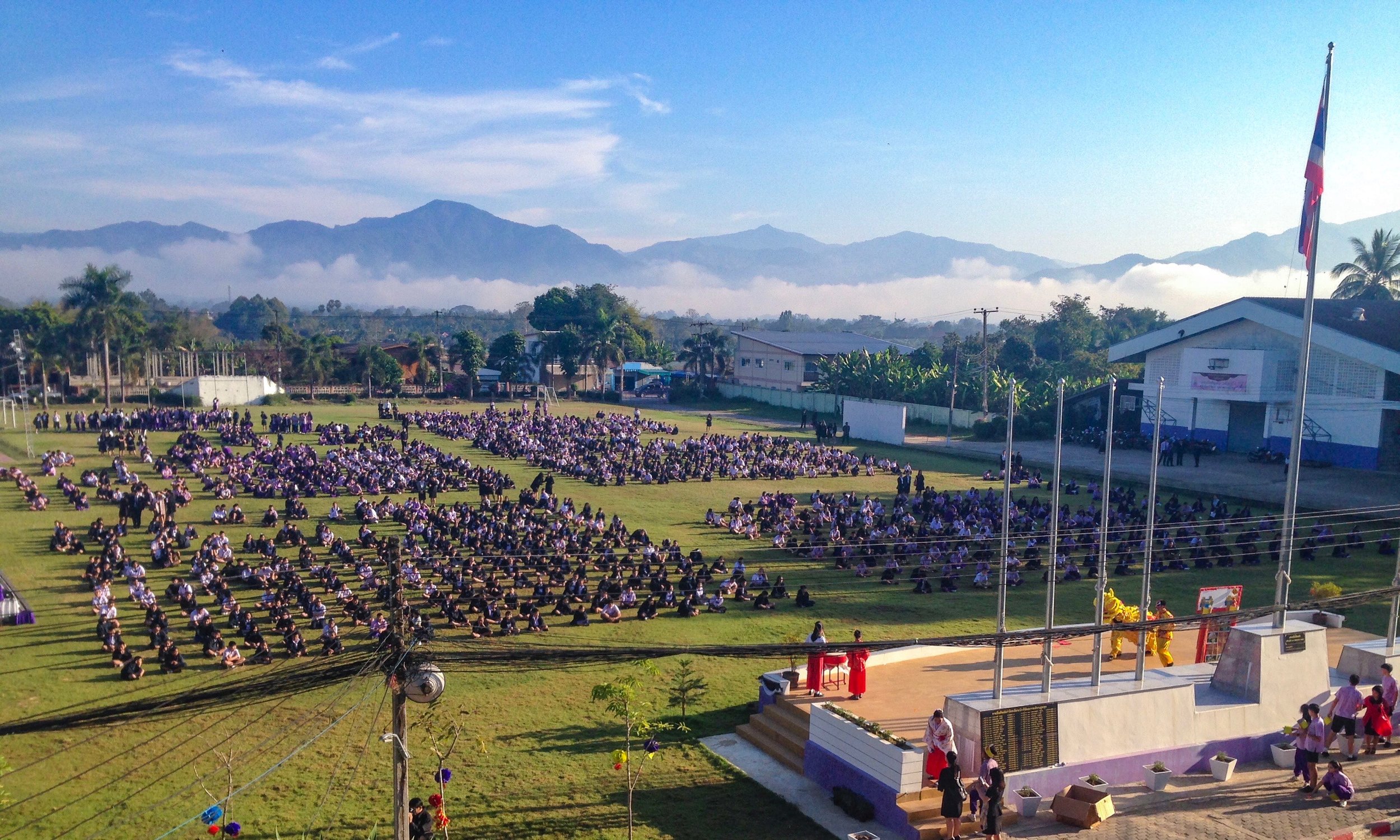 Students line up on the field each morning to sing their National Anthem, pray, and sing the King's song. Some mornings, such as this one, there are announcements or performances at the meeting. 