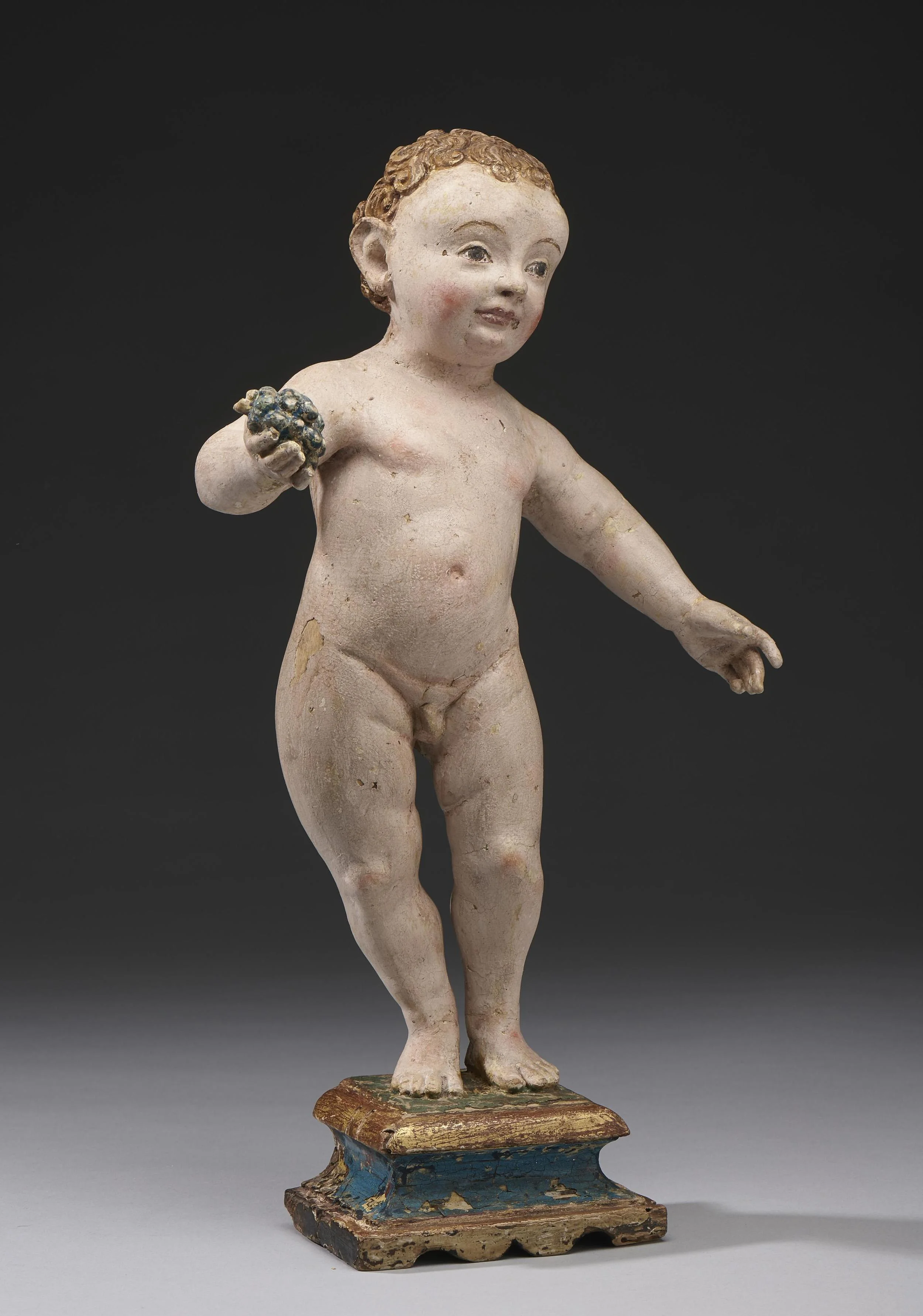 STANDING CHRIST CHILD WITH GRAPES Rhineland (Cologne) circa 1500 Linden wood with original polychromy, mounted on original base Height with base: 36.5 cm