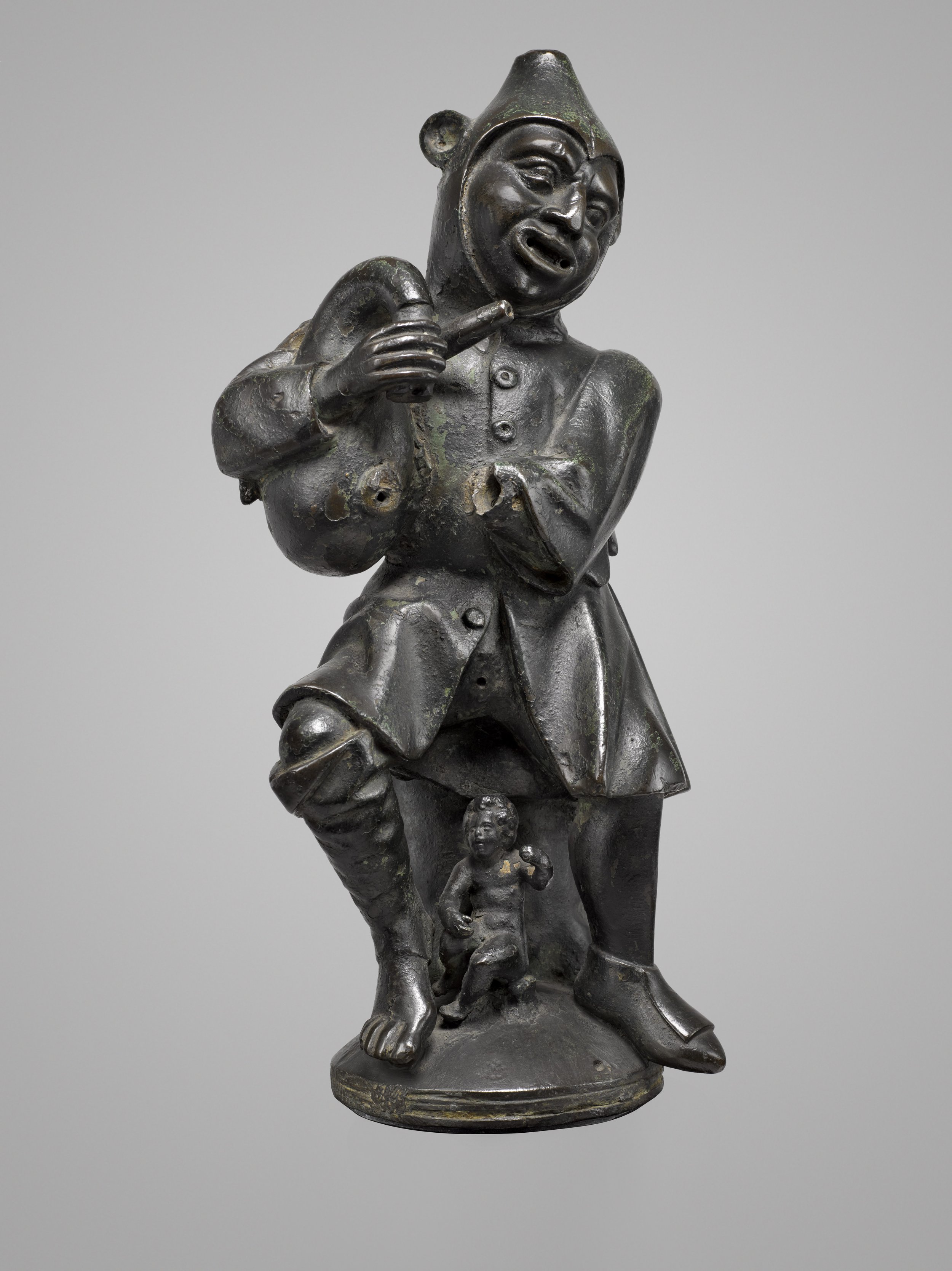   AEOLIPIL IN THE SHAPE OF A JESTER    ATTRIBUTED TO THE VISCHER FAMILY WORKSHOP 1453-1549    Nuremberg  Third quarter of the 15th century   Bronze  Height: 18 in (45.7 cm)  Diameter: 4 ¾ in (12.1 cm) 