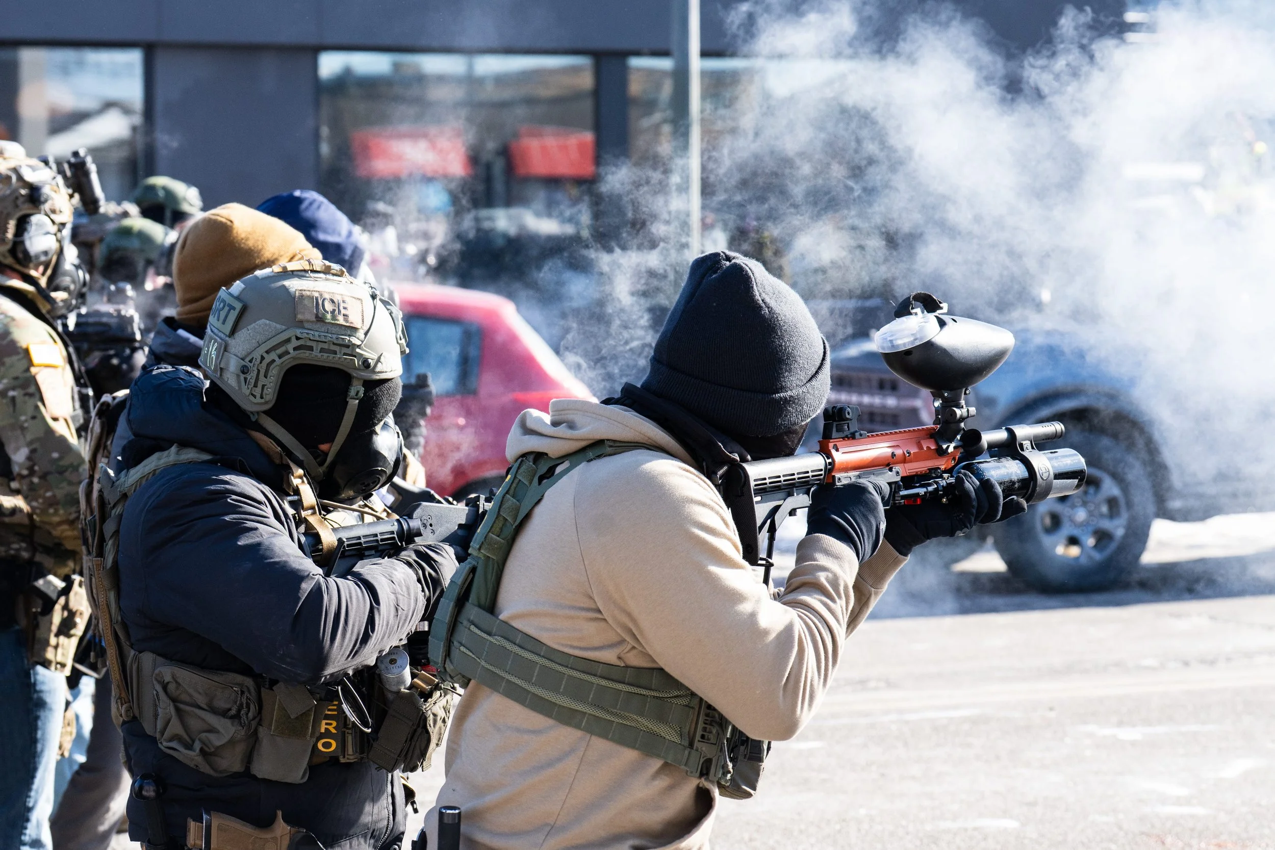 Image of law enforcement shooting tear gas into crowd of protestors