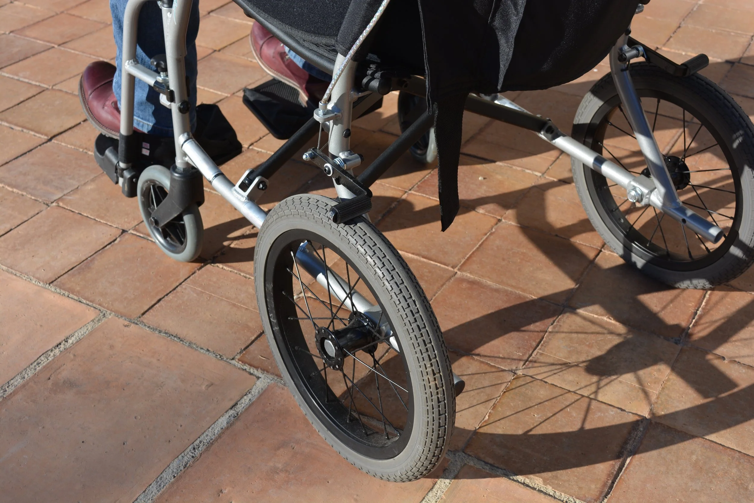 wheelchair-rolling-on-a-stone-tile-surface