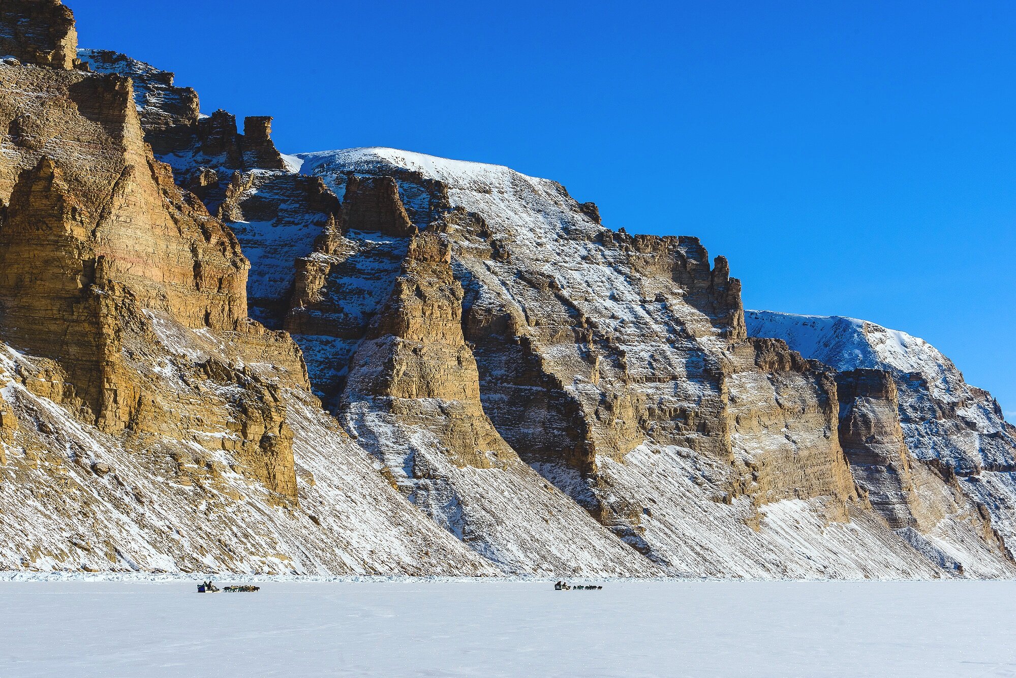 Inuit Hunters Traveling Over The Sea Ice