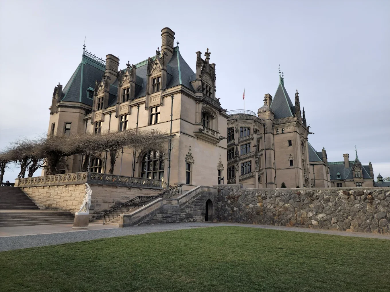 Grand historic mansion exterior with stone terrace walls and ornate architecture in Asheville, North Carolina