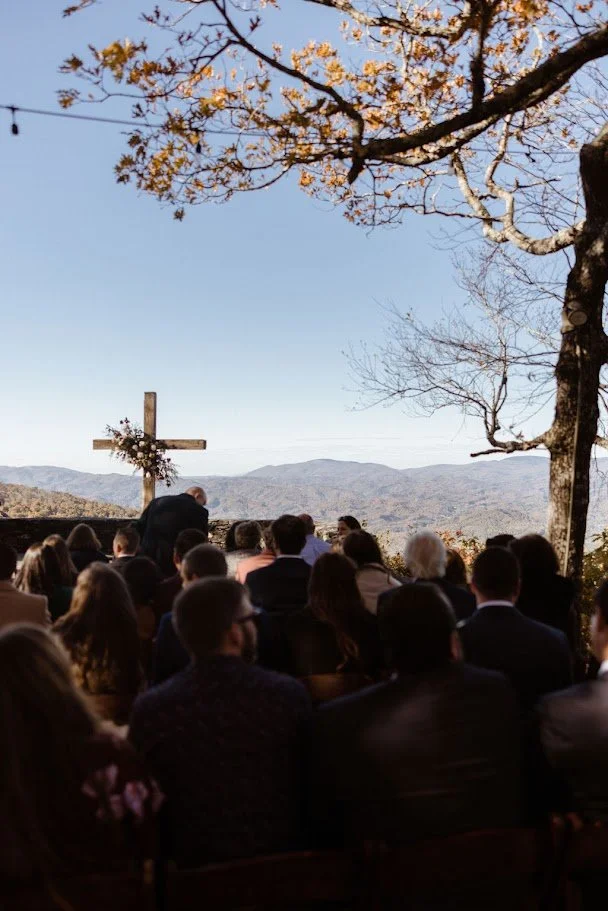 Autumn woodland path lined with a stone wall and fall trees at a wedding venue