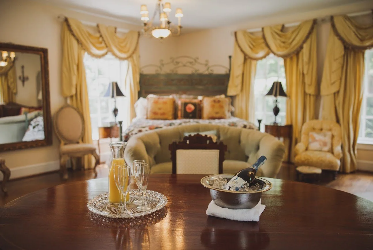 Bridal suite table with champagne on ice, orange juice, and flutes in an elegant room.