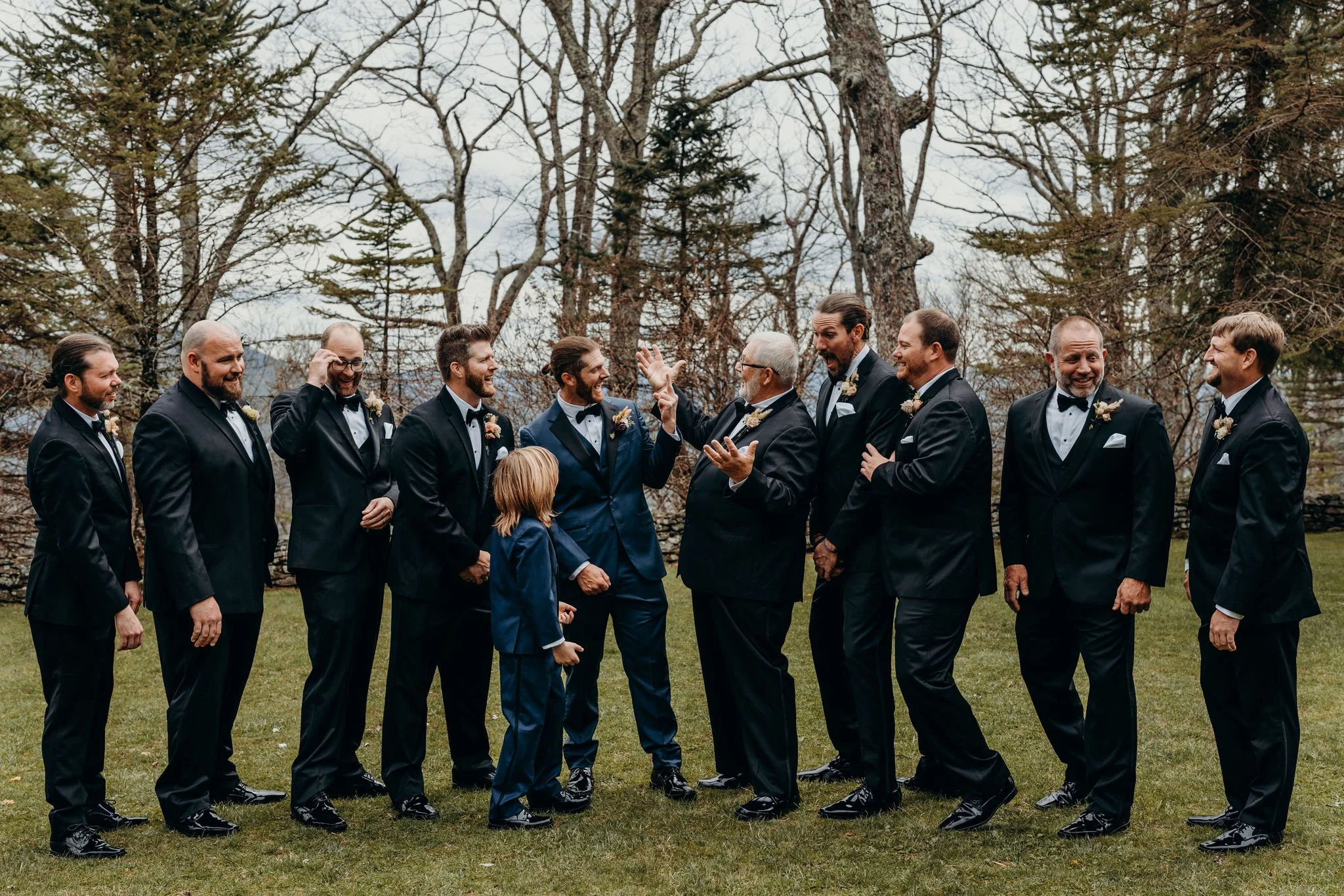 Couple and child walking up the aisle after an outdoor mountain ceremony as guests watch.