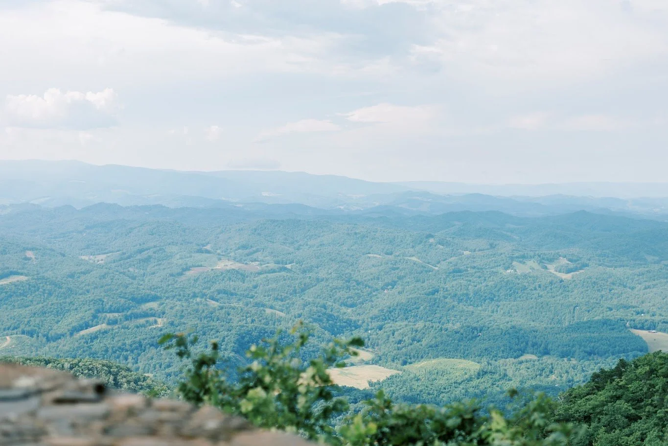 Scenic view of rolling mountains and valleys from a high overlook on a bright day