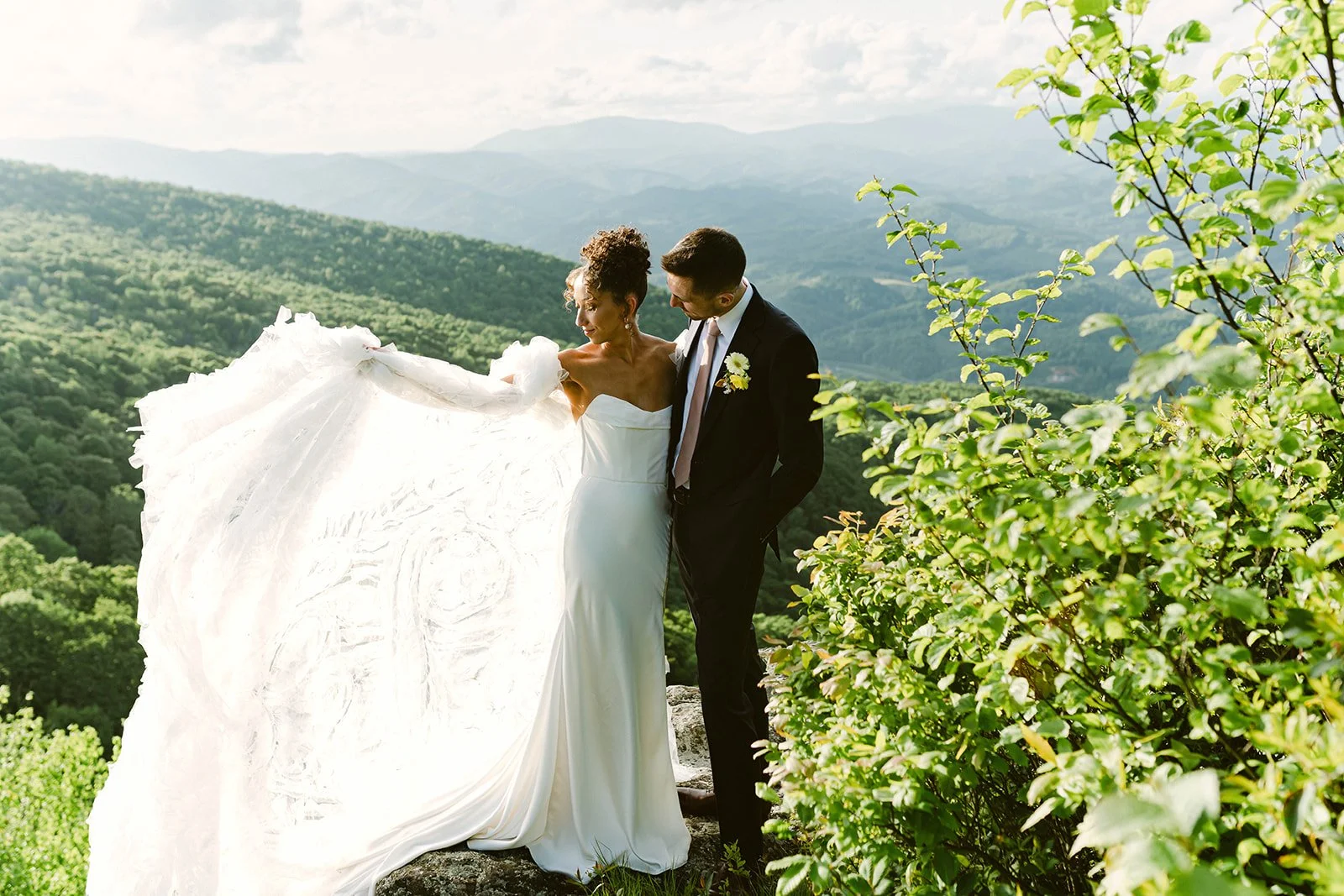 mountaintop-wedding-couple-portrait-bride-holding-train