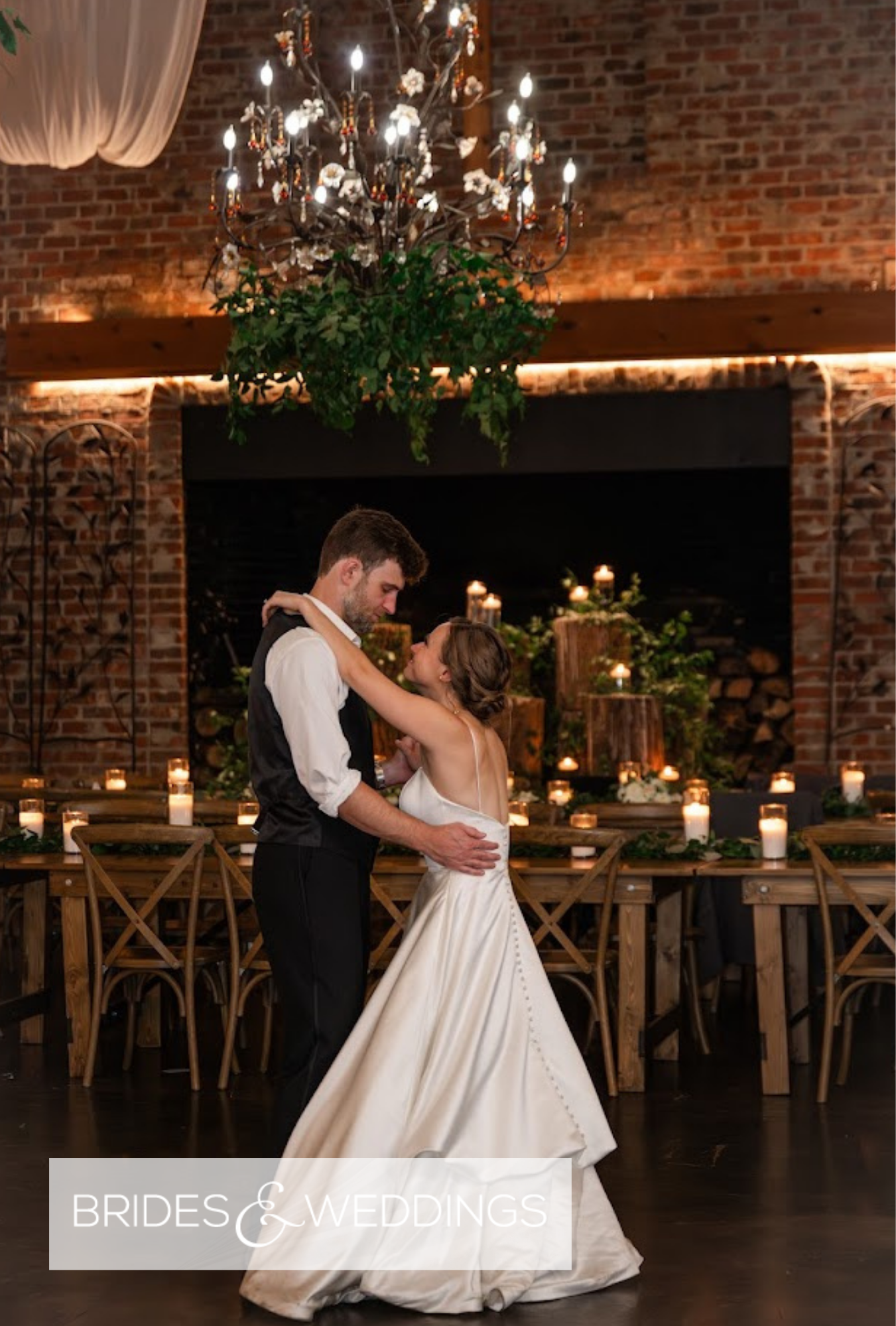 Melanie and Cameron wedding video cover showing the couple dancing in an industrial reception space with brick walls and chandeliers.
