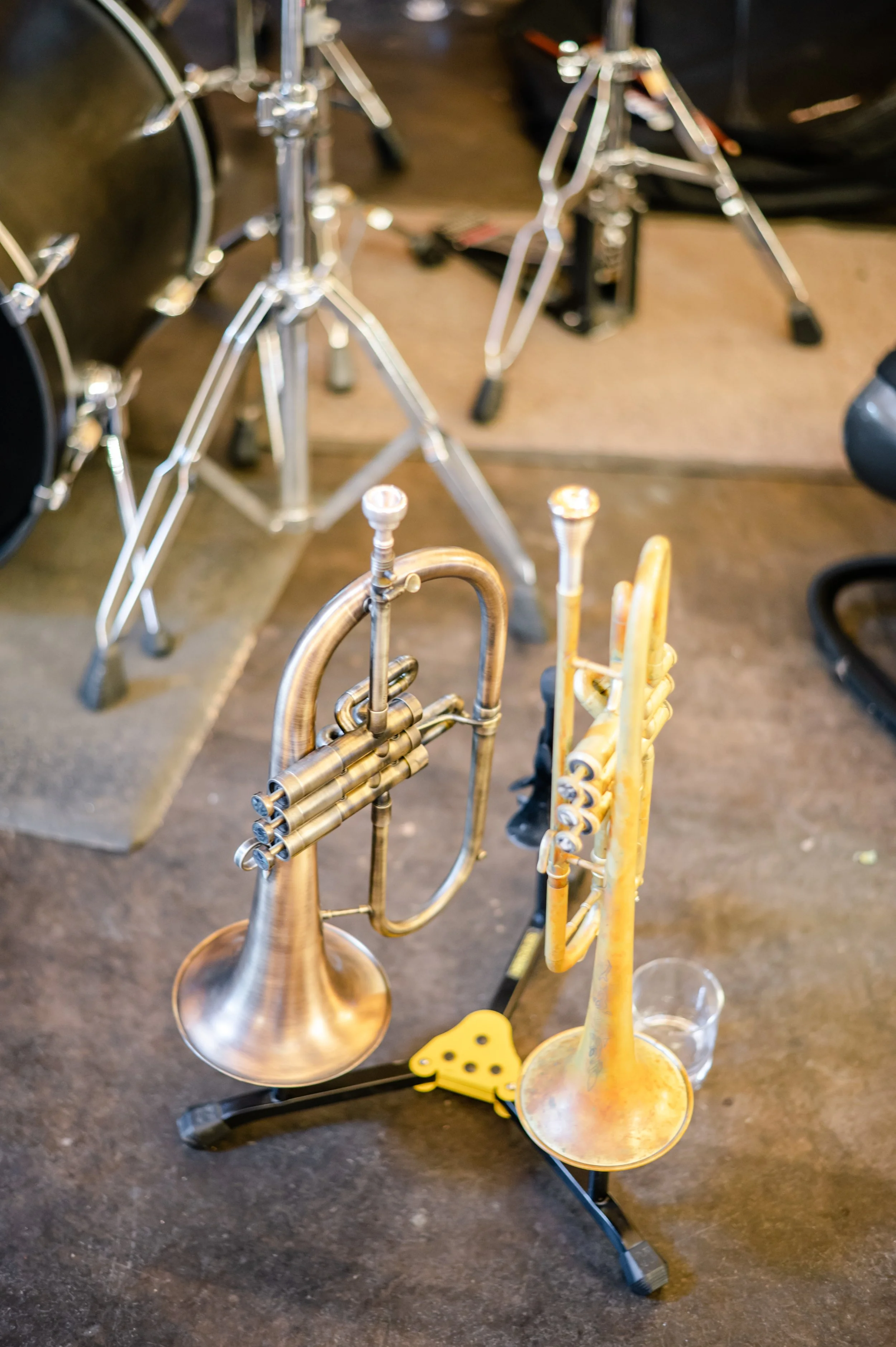 Brass instruments arranged on the floor as a live music detail for a wedding reception.