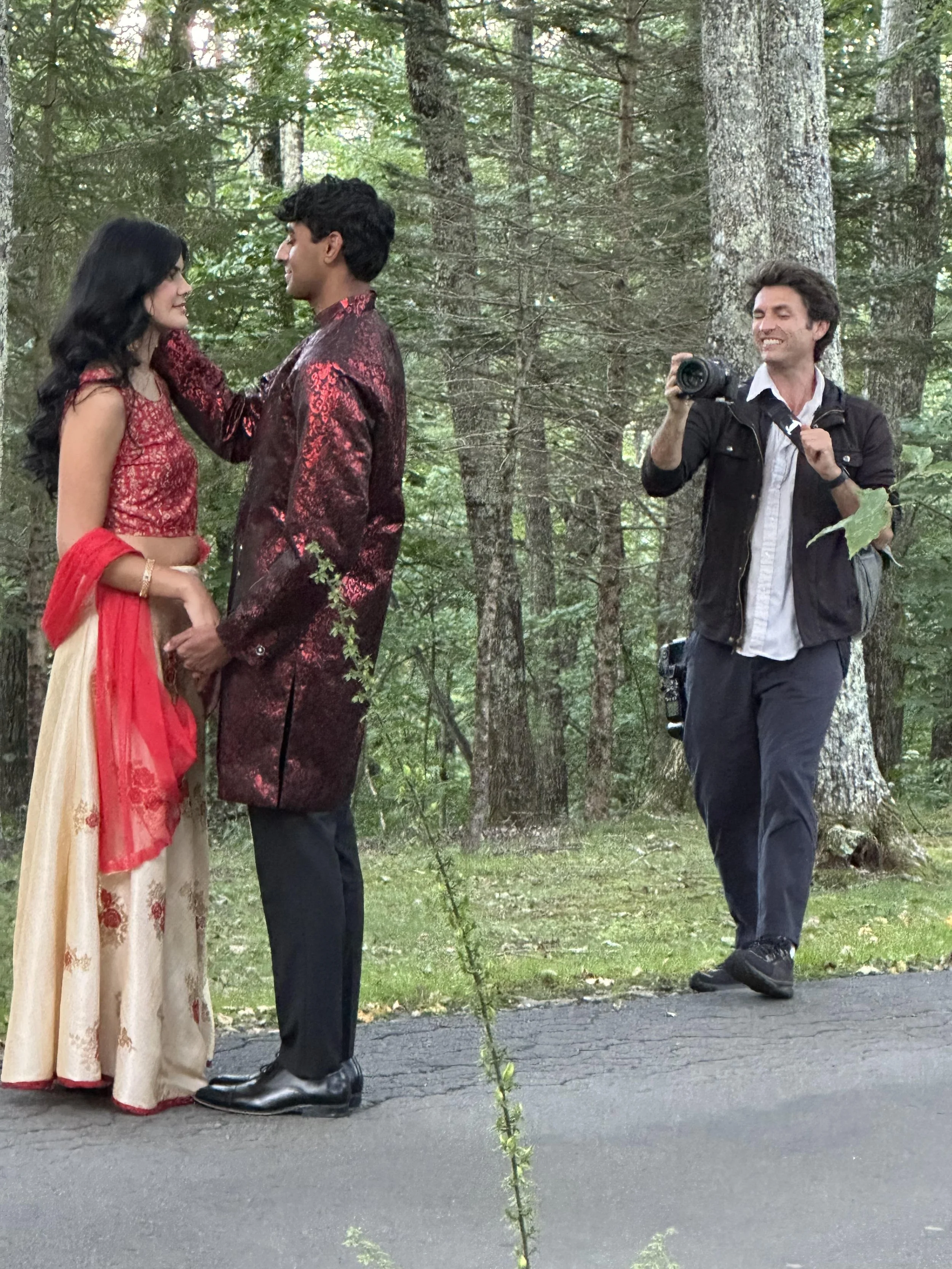 Videographer filming an Indian wedding couple in a forest setting during portraits