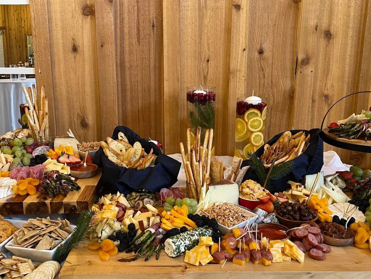 Wedding cocktail hour grazing table with charcuterie, fruit, crackers, and dips
