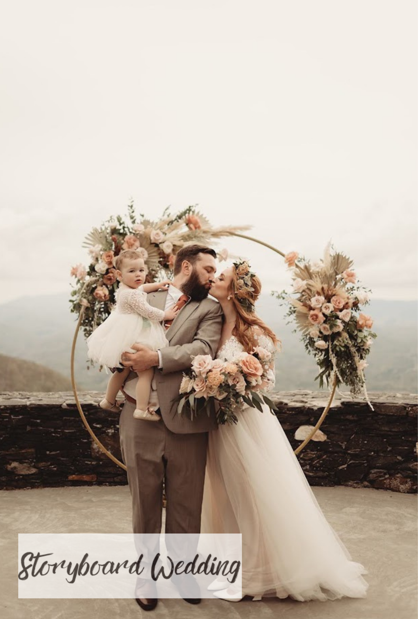 Lindsey and Daniel wedding video cover featuring the couple kissing beneath floral circle arches in a foggy mountain setting.