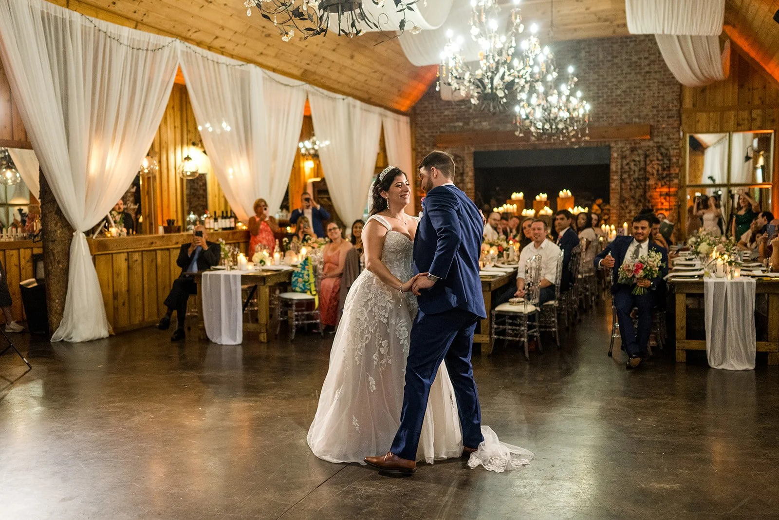 bride-and-groom-first-dance-in-rustic-chandelier-reception.jpg