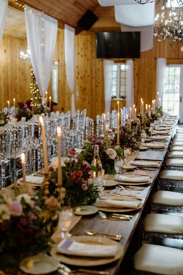 Brick estate wedding venue exterior in fall with gables, chimneys, and landscaped lawn