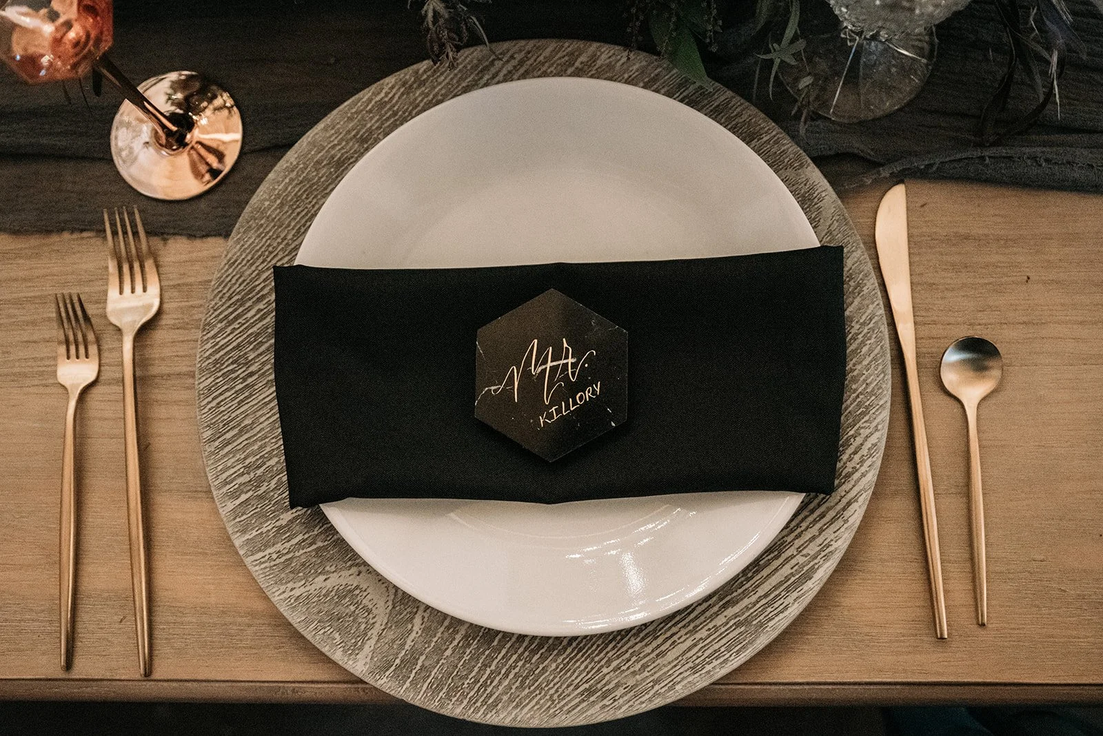 Rustic wedding welcome table with rolled blankets, cameras, and guest items arranged outdoors.