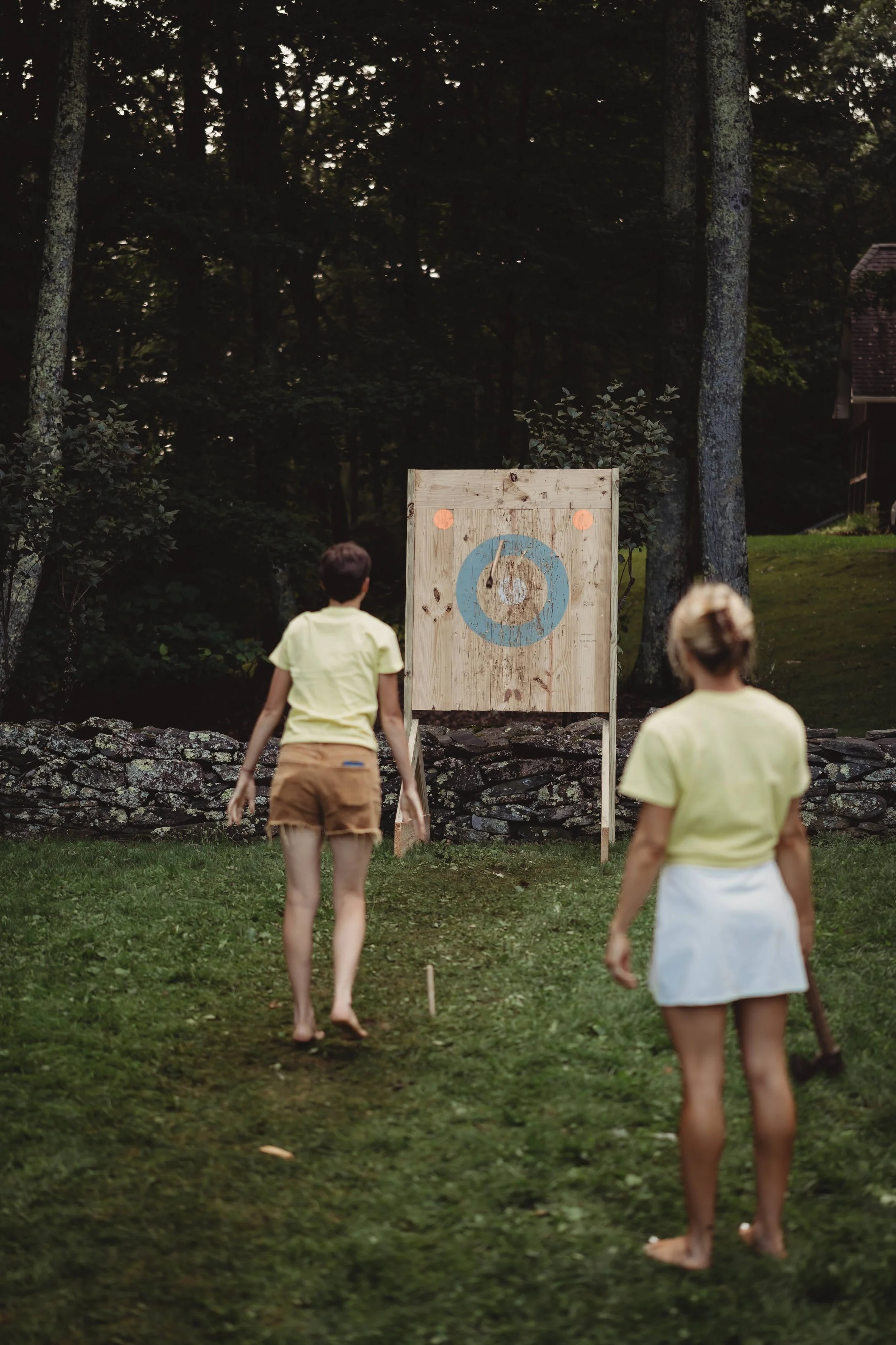 Guests playing croquet on a grassy lawn during a wedding weekend