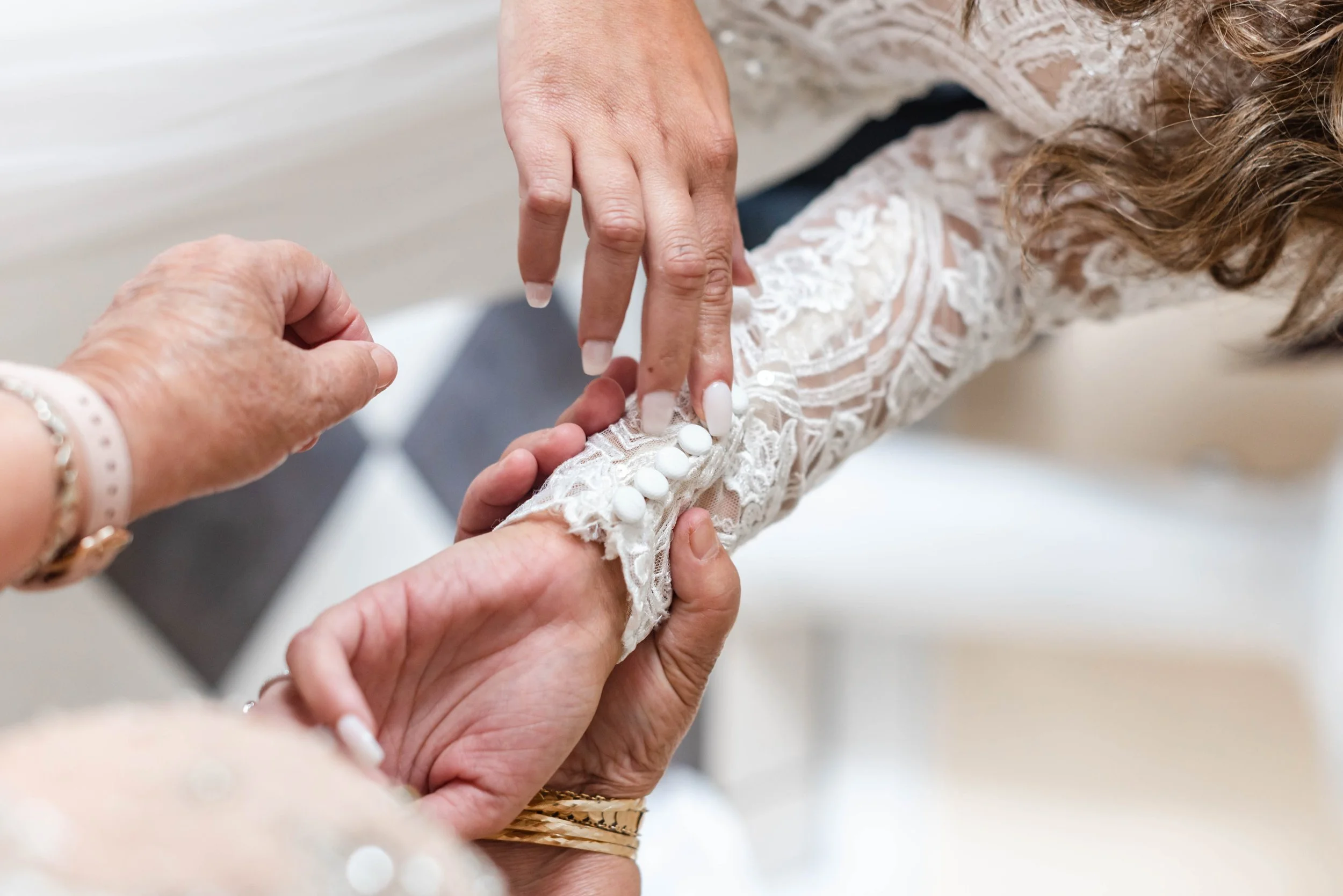 Close-up of a wedding ring exchange during an outdoor mountain ceremony.