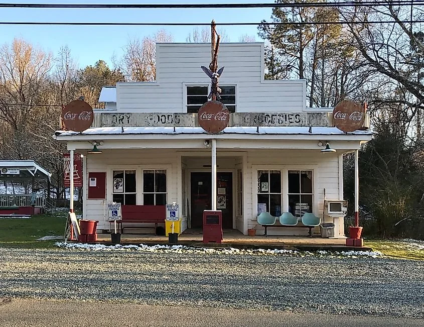 Old Orchard General Store with a front porch, rocking chairs, and vintage signage