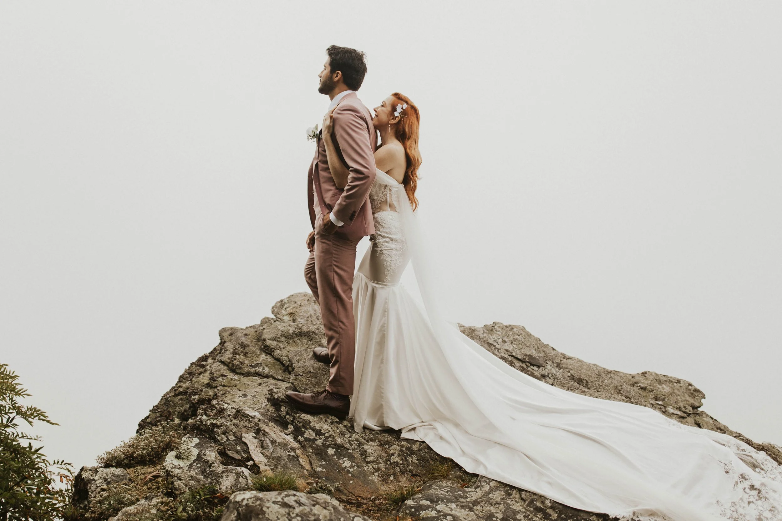 bride-and-groom-on-rocky-mountain-cliff.jpg