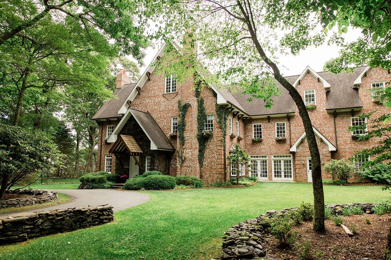 Brick estate wedding venue exterior with ivy-covered walls, gables, and manicured lawn