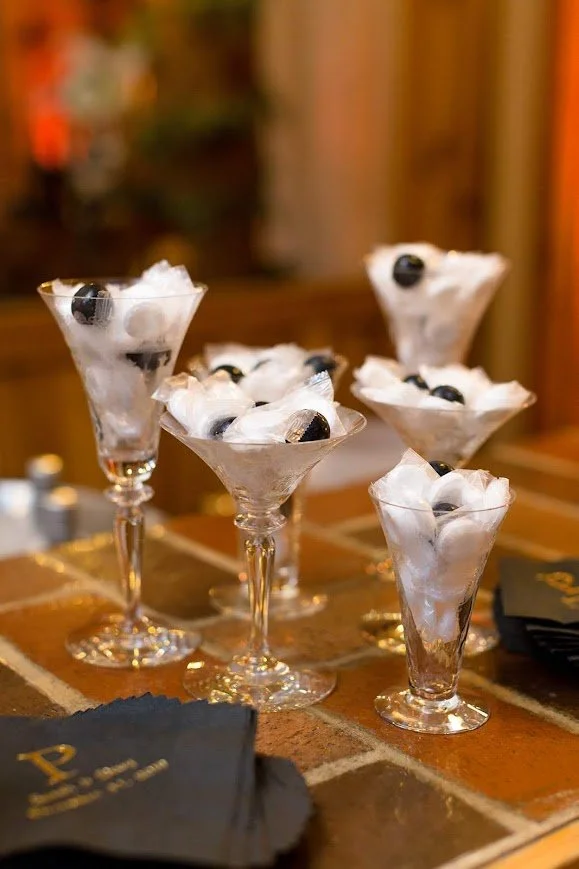 Individual dessert parfaits served in glassware on a rustic tabletop