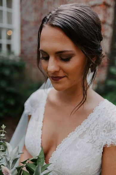 Close-up of wedding ceremony florals with white roses, blush roses, hydrangea, and greenery