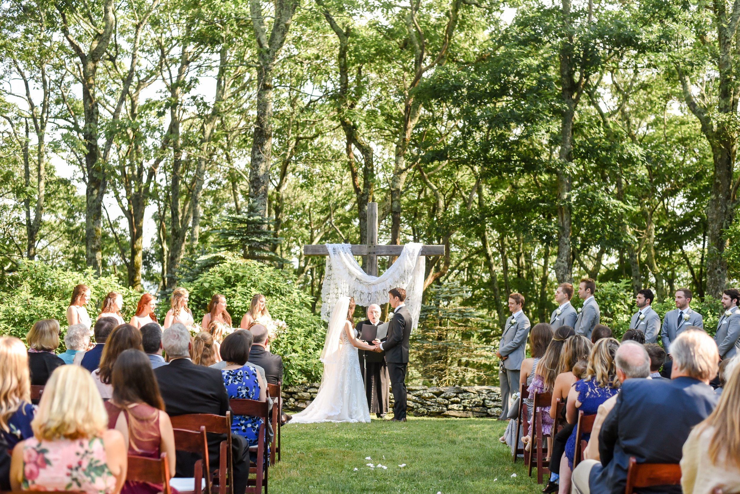outdoor-woodland-wedding-ceremony-cross-draped-fabric