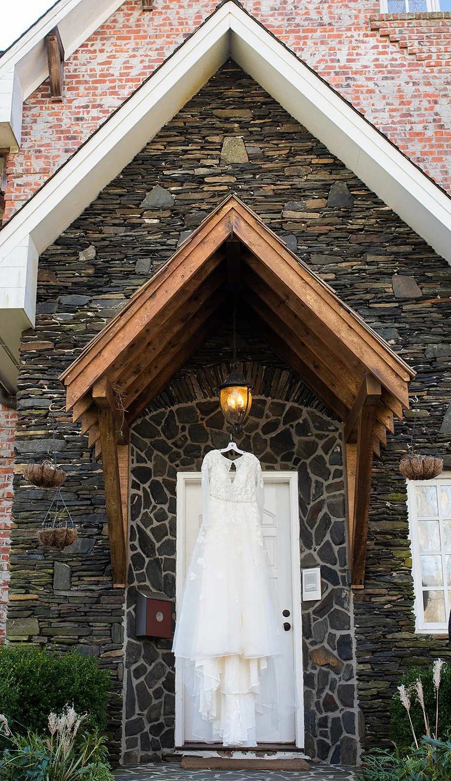 Outdoor ceremony site with rows of chairs facing a wooden arbor draped with white fabric.
