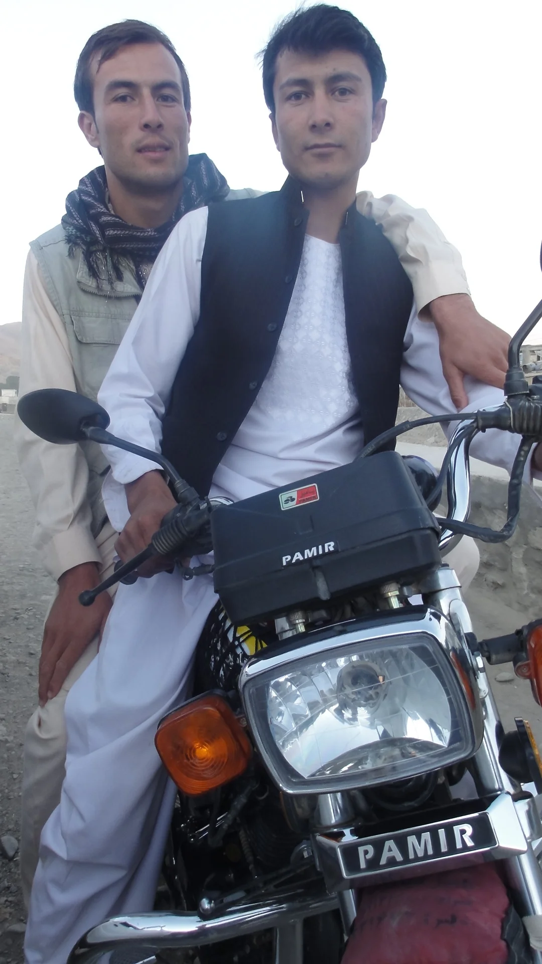 Afghans in Bamyan riding in tandem on Pamiri motorbike.JPG