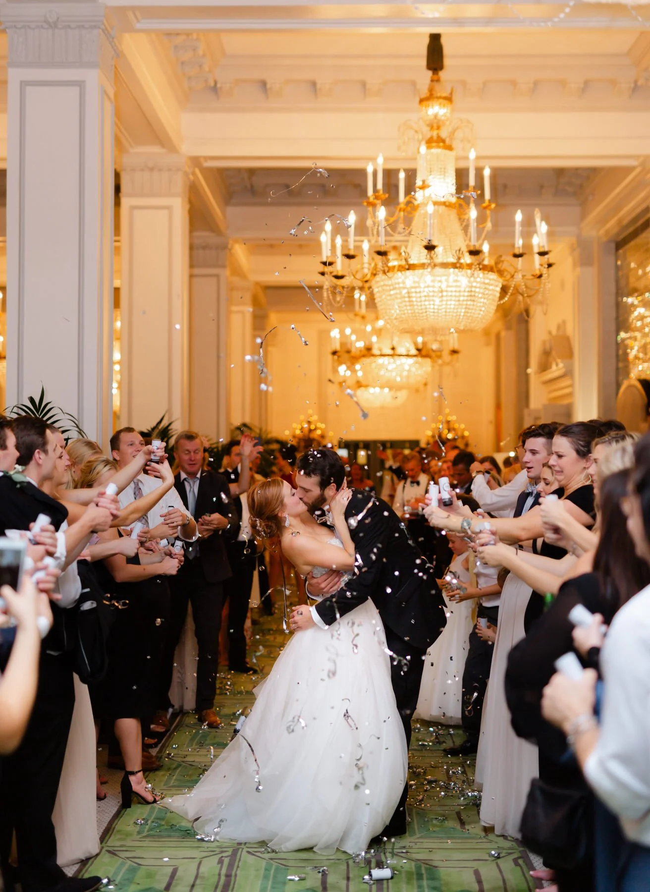 bride-groom-confetti-exit-kiss-peacock-alley-st-anthony-wedding.jpg