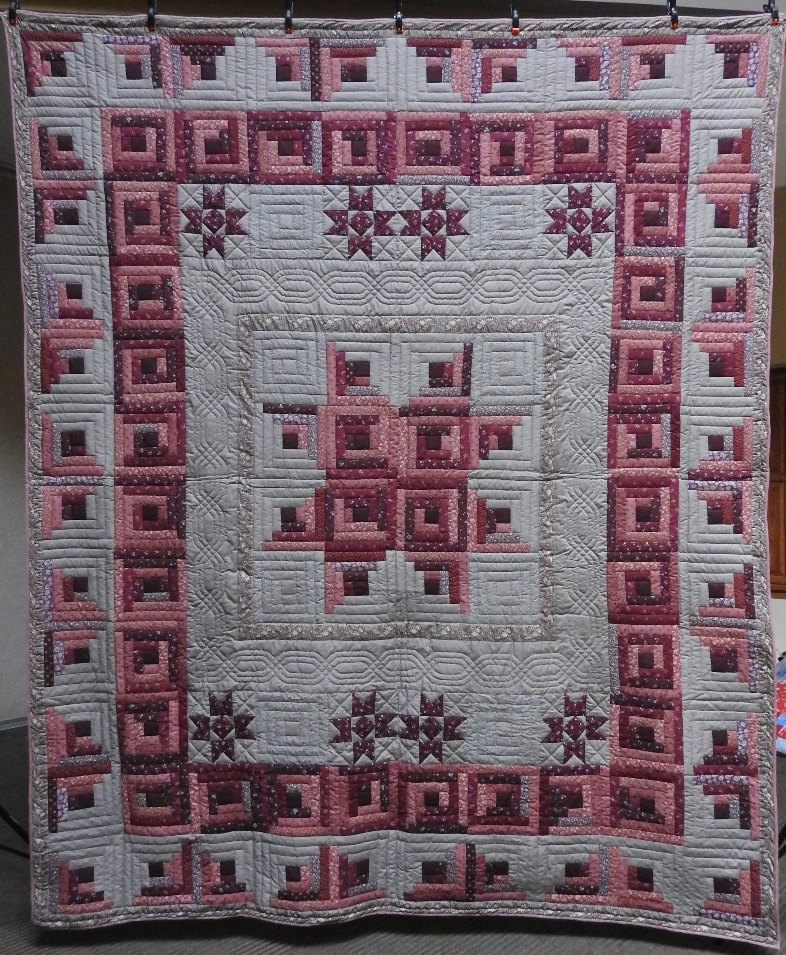  Stars over the Log Cabin, Pieced, Hand Quilted, donated by The Depot Quilt Room, 96 x 113”