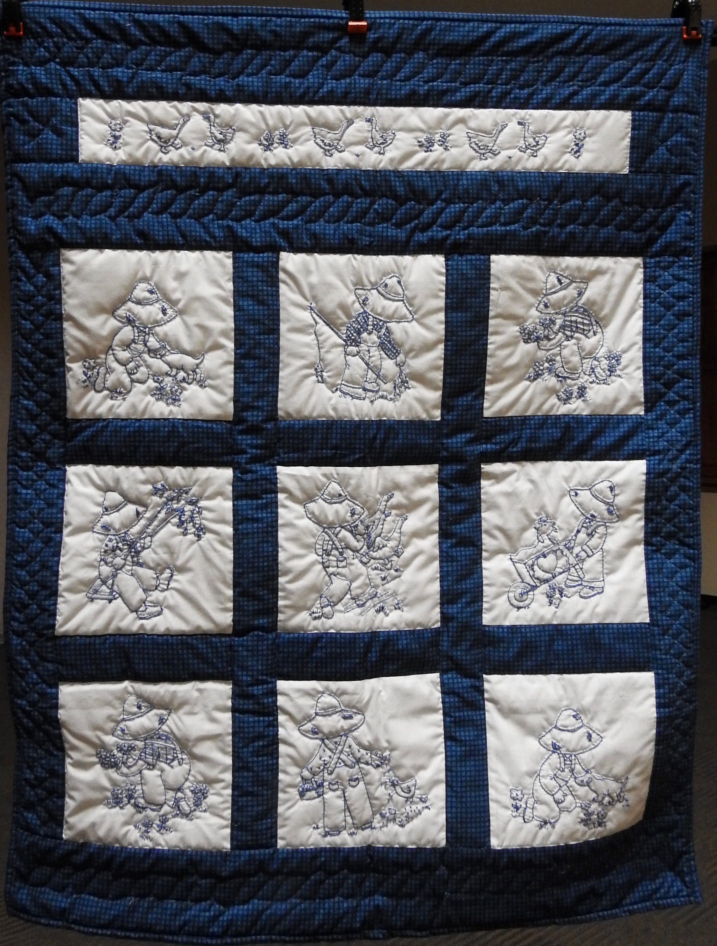 Overall Sam in Blue, Pieced &amp; Embroidered, Hand Quilted by Susie Schlabach, donated Anonymously, 37 x 46