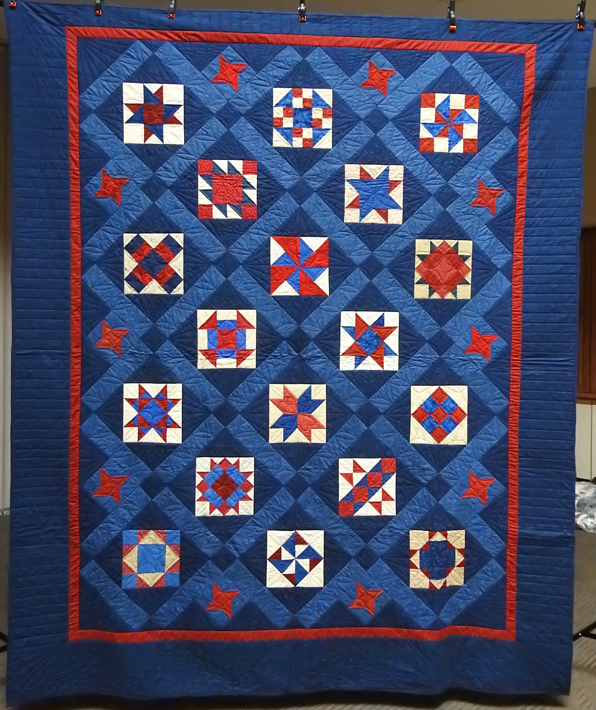 Blue &amp; Red Sampler, Pieced, Custom Machine Quilted, donated Anonymously, 87 x 104”