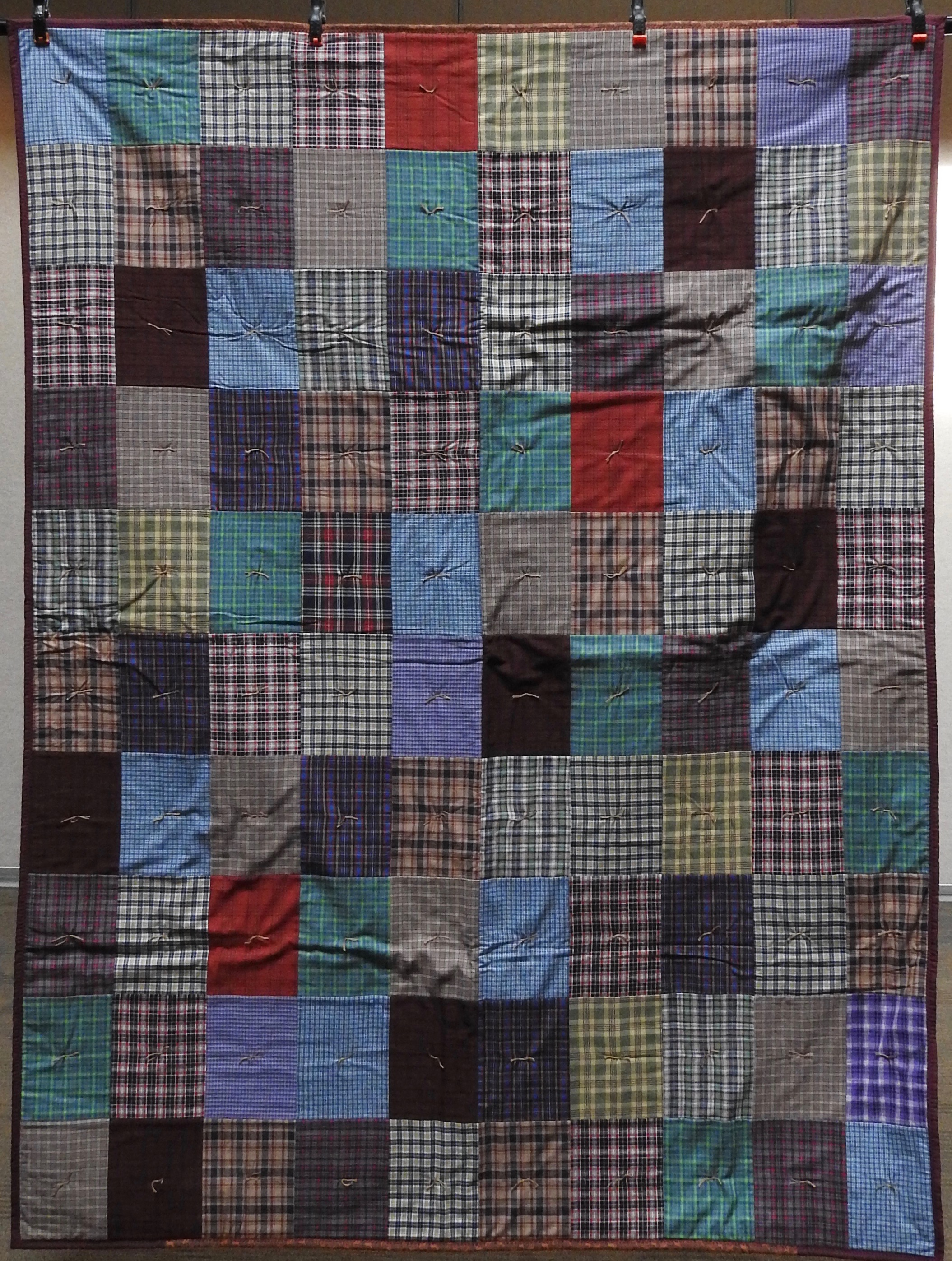 North Country Cabin, Pieced, Knotted, donated by Ann Pasnick, 60 x 80”
