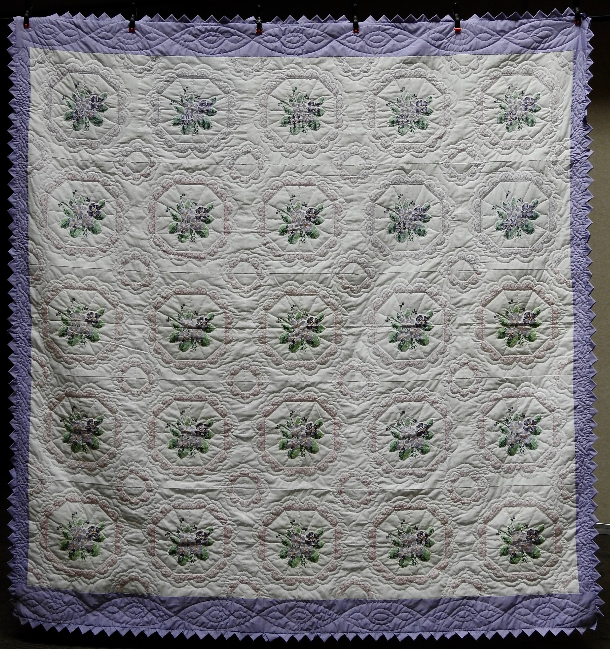 Cross Stitched Violets, Pieced, Cross Stitched, Hand Quilted, donated by Howard-Miami Mennonite Church, 89 x 95”