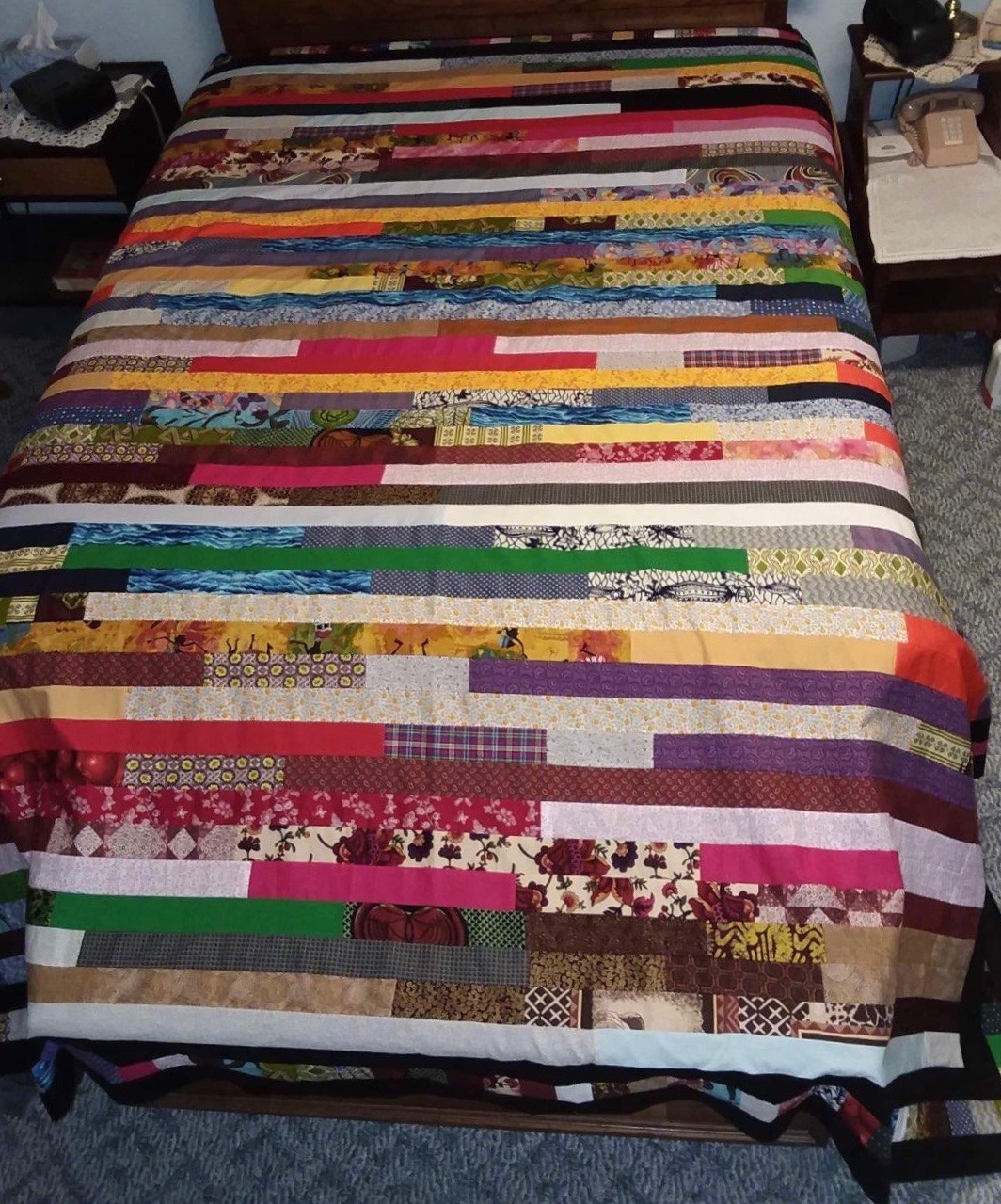  Joseph’s Coat Comforter, Pieced by Mary Gilliom, Reactor Knotted, donated by Silverwood Mennonite Women, 106 x 107”