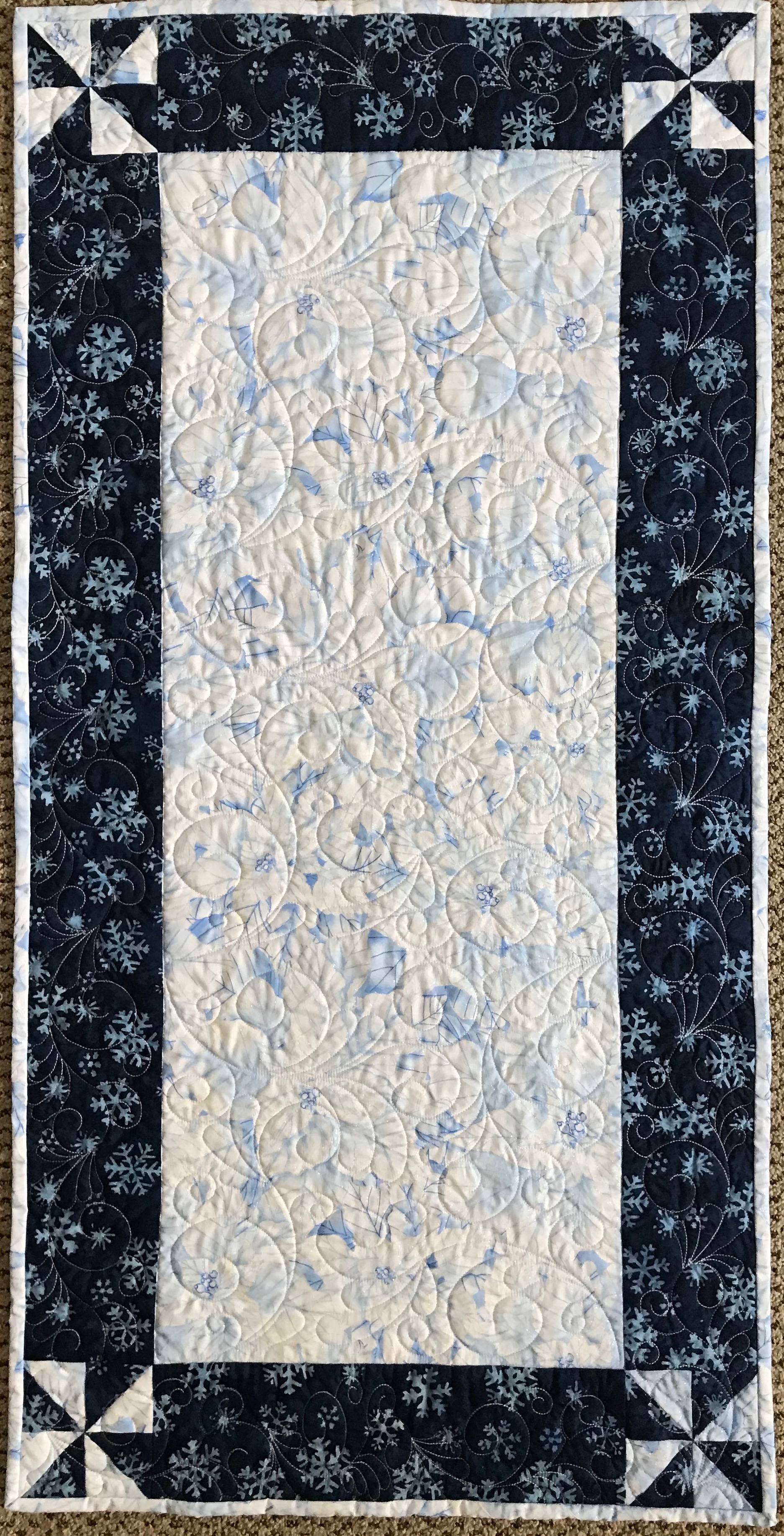 Winter’s Sparkle, Pieced &amp; Custom Machine Quilted by Debra Detwiler, donated by Debra Detwiler, 21 x 42”