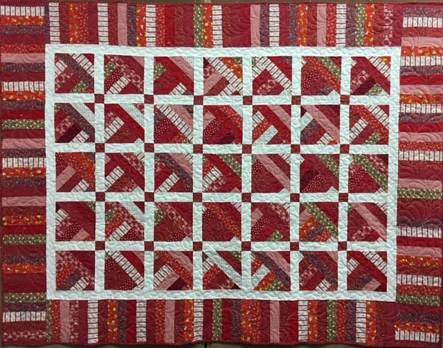  Happy Scrappy Red Brick Road, Pieced by Colleen Stoltzfus, Edge to Edge Machine Quilted, donated by Silverwood Mennonite Women, 70 x 90”