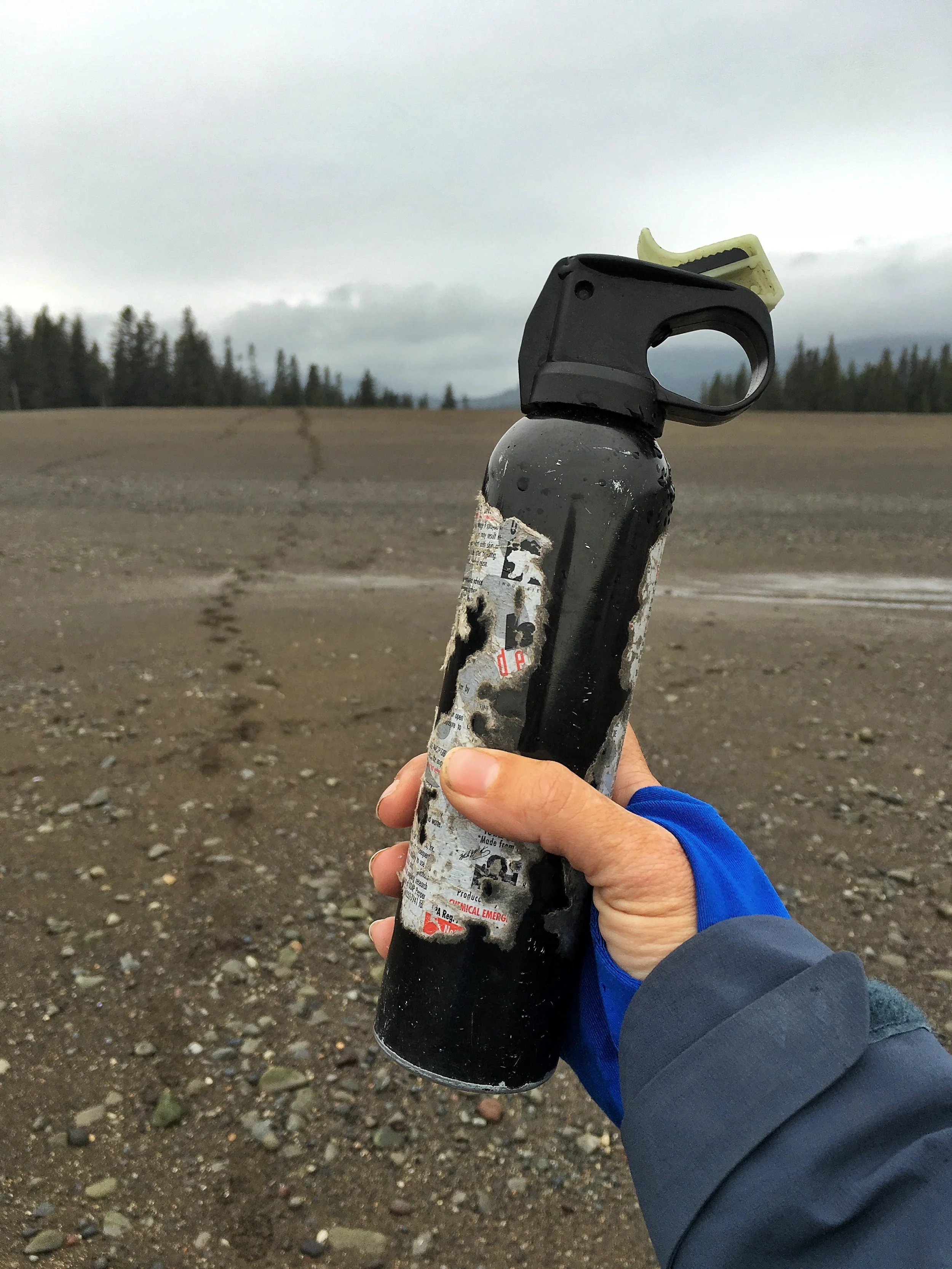 Stef taking off into bear country in Lake Clark Alaska with a can of bear spray, also known as "a can of confidence." 