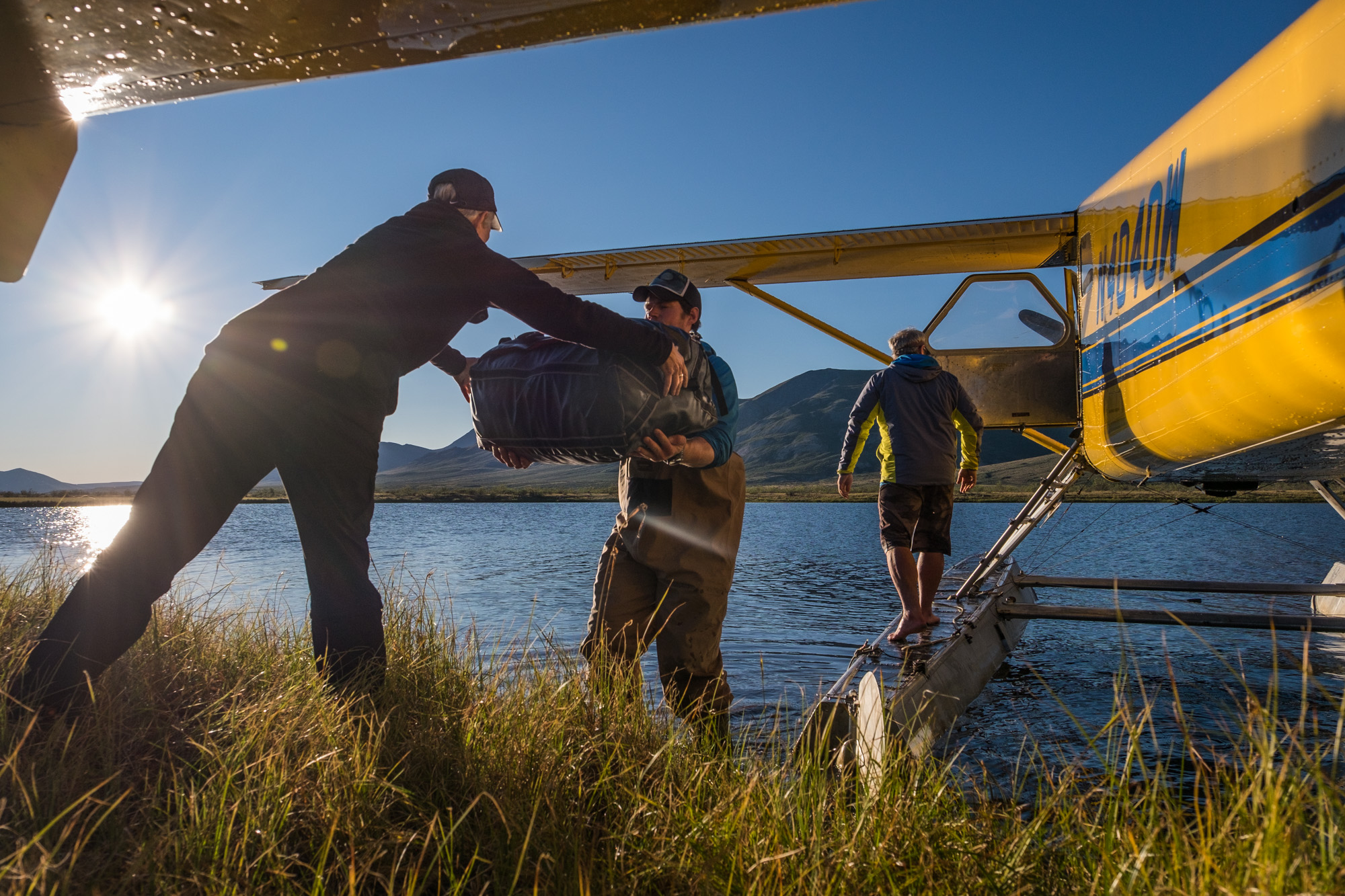 Our fearless guides from Alaska Alpine Adventures, Nick and Sean, shuffle gear from the float plane to our first camp on the Noatak River. 