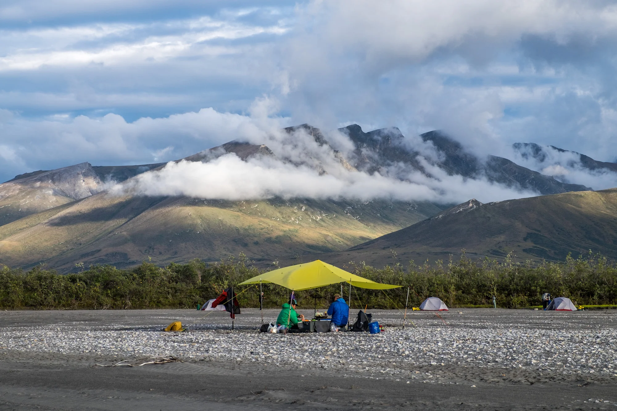 Our guides, Sean and Nick, prepare dinner for a ravenous crew at our riverside backcountry campsite.