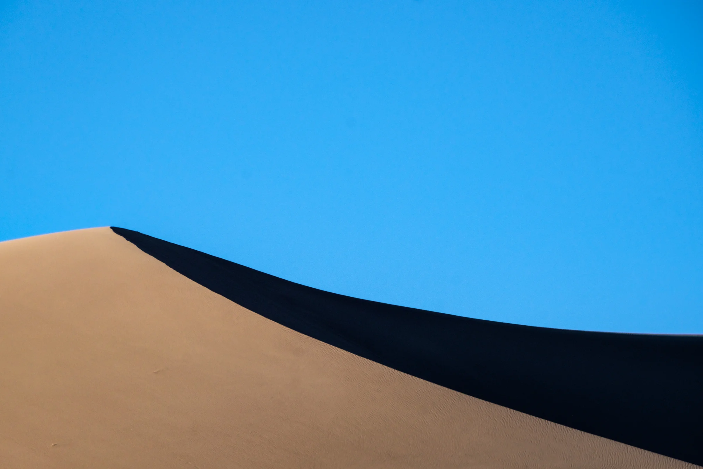 "Barchan dunes" create what is considered a perfect half moon, and appear flattened on the surface. 