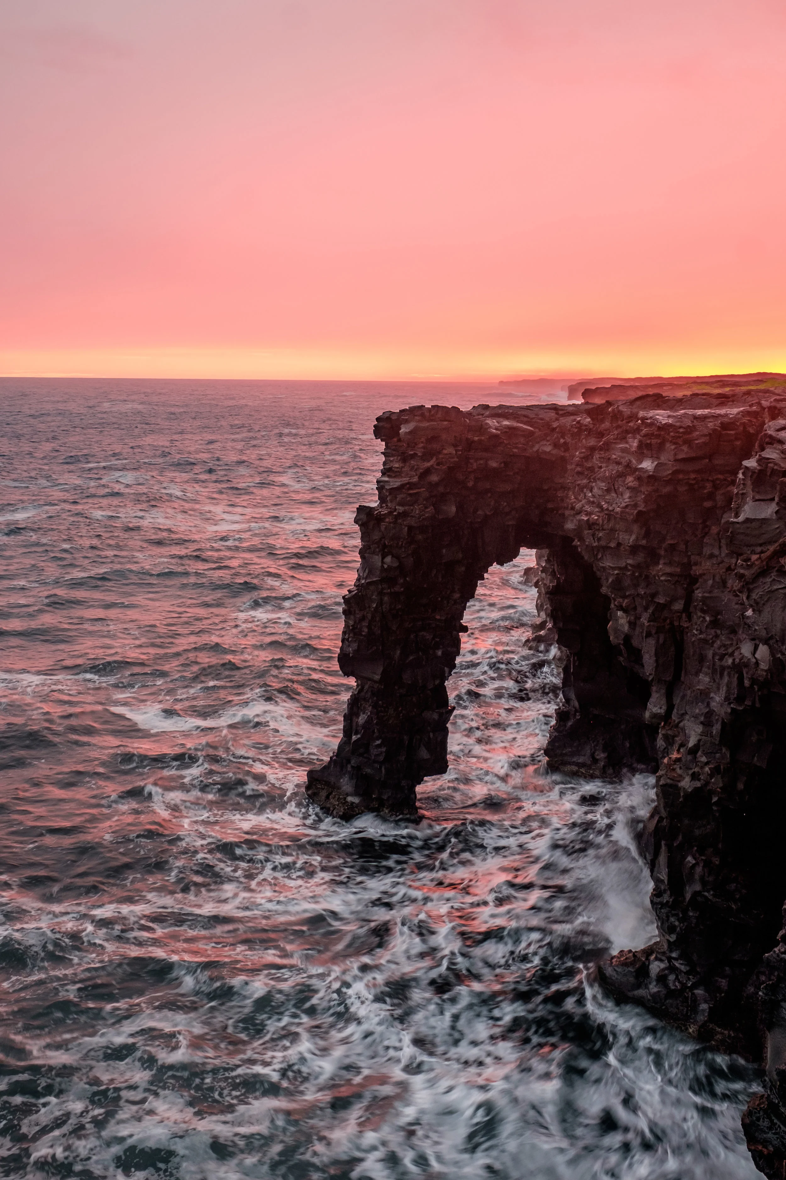 The Hōlei Sea Arch warmed at sunset.