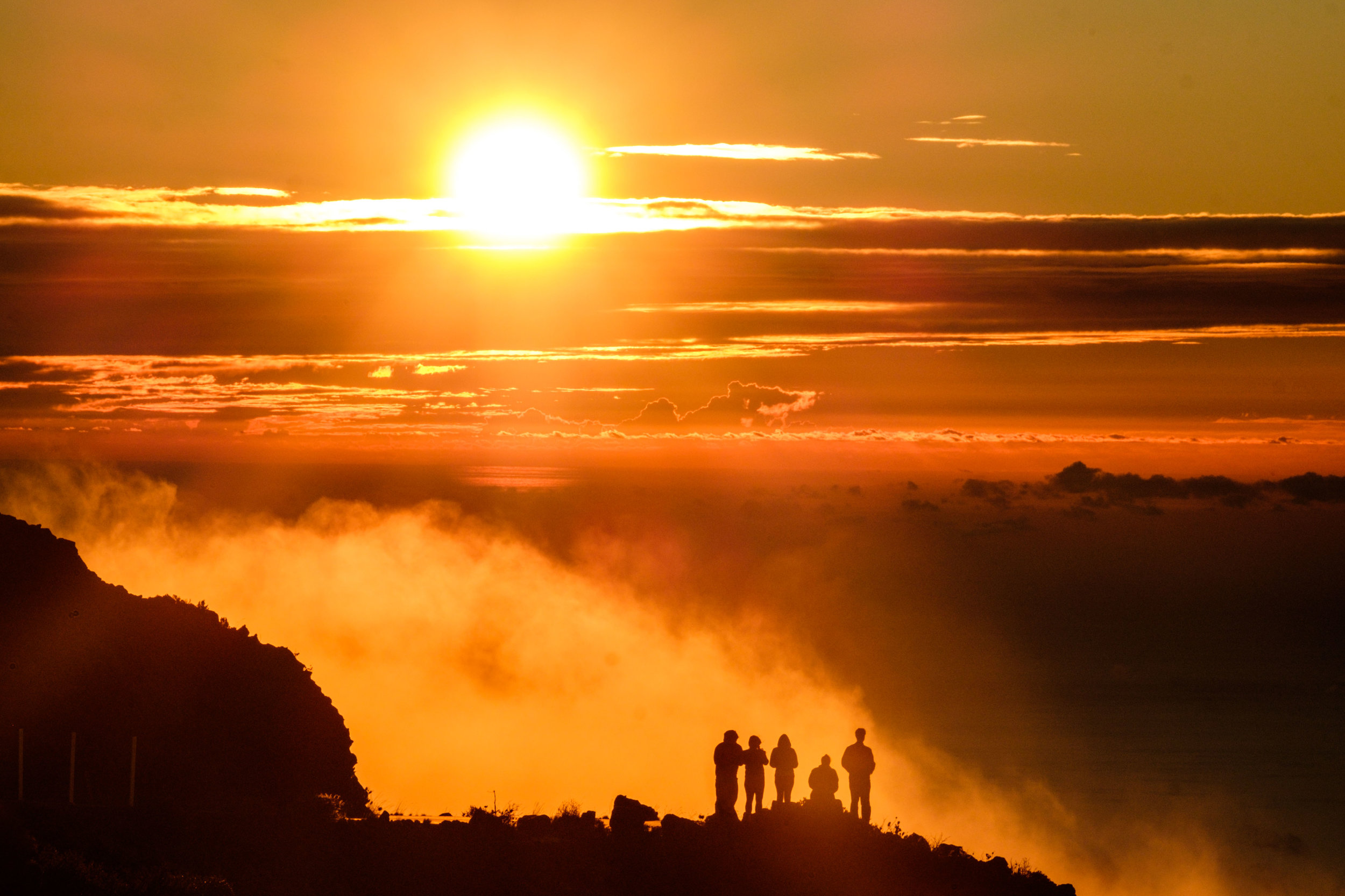 Friends sharing a sunset view on the high peaks of Haleakala off of Crater Road.