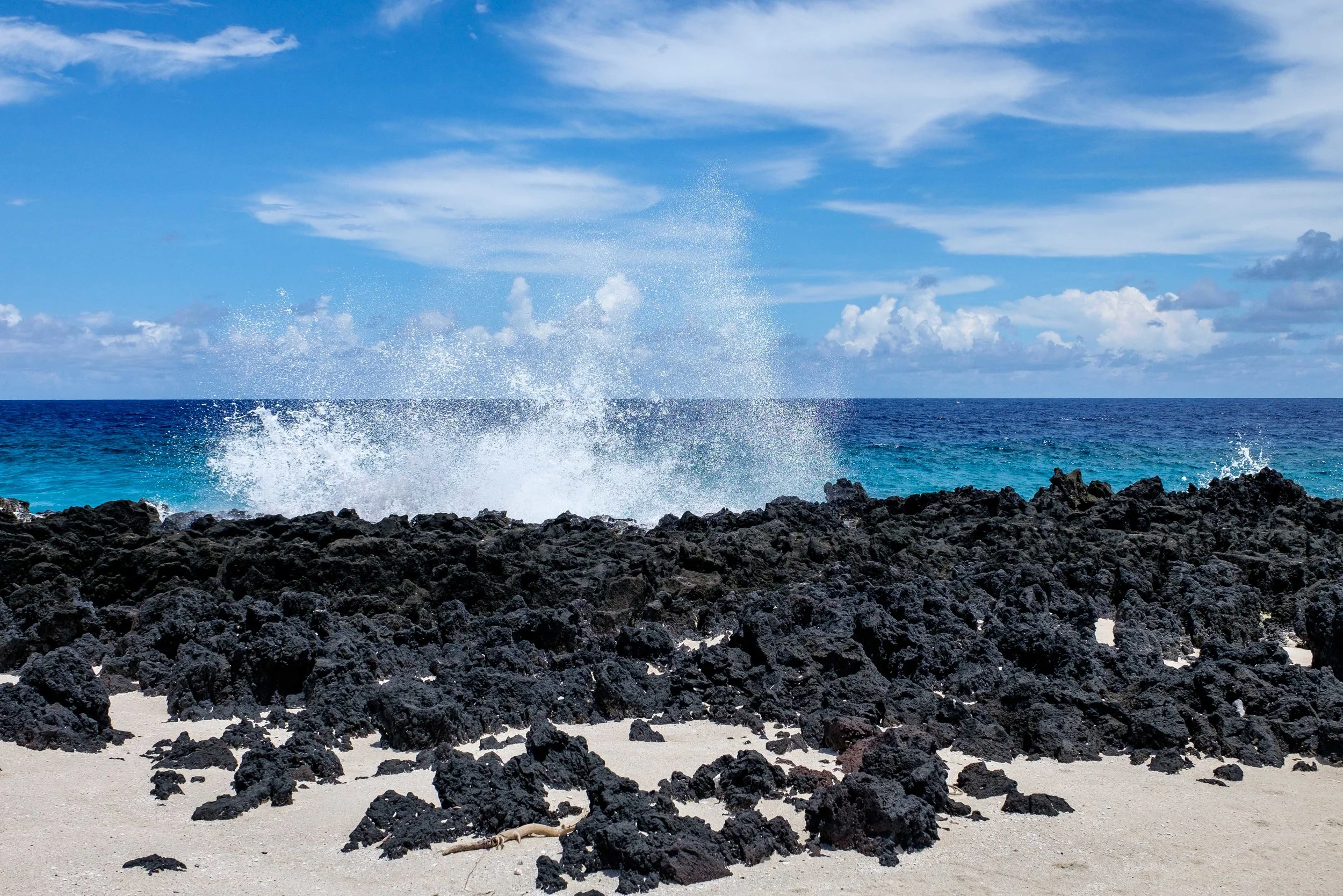 The sea crashes over volcanic shoreline in the national park in Ta'u. 