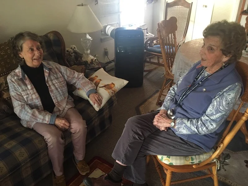 Client Wanetta Nurse (left) and senior companion Kitty Gee chat about topics like family, the good old days, and men.