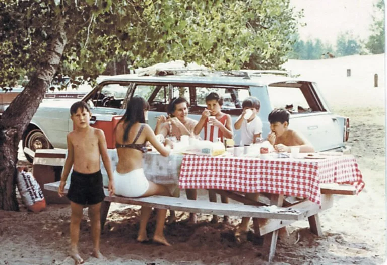 “Every Lyons family vacation began by packing the station wagon with children, coolers, and suitcases. We always stopped for lunch along the road—whenever my dad, Frank, spotted a picnic table,” says Susan Lyons Dietrich. “Lunch was always the same: bologna sandwich, potato chips, and Kool-Aid.” COURTESY SUSAN LYONS DIETRICH/REMINISCE