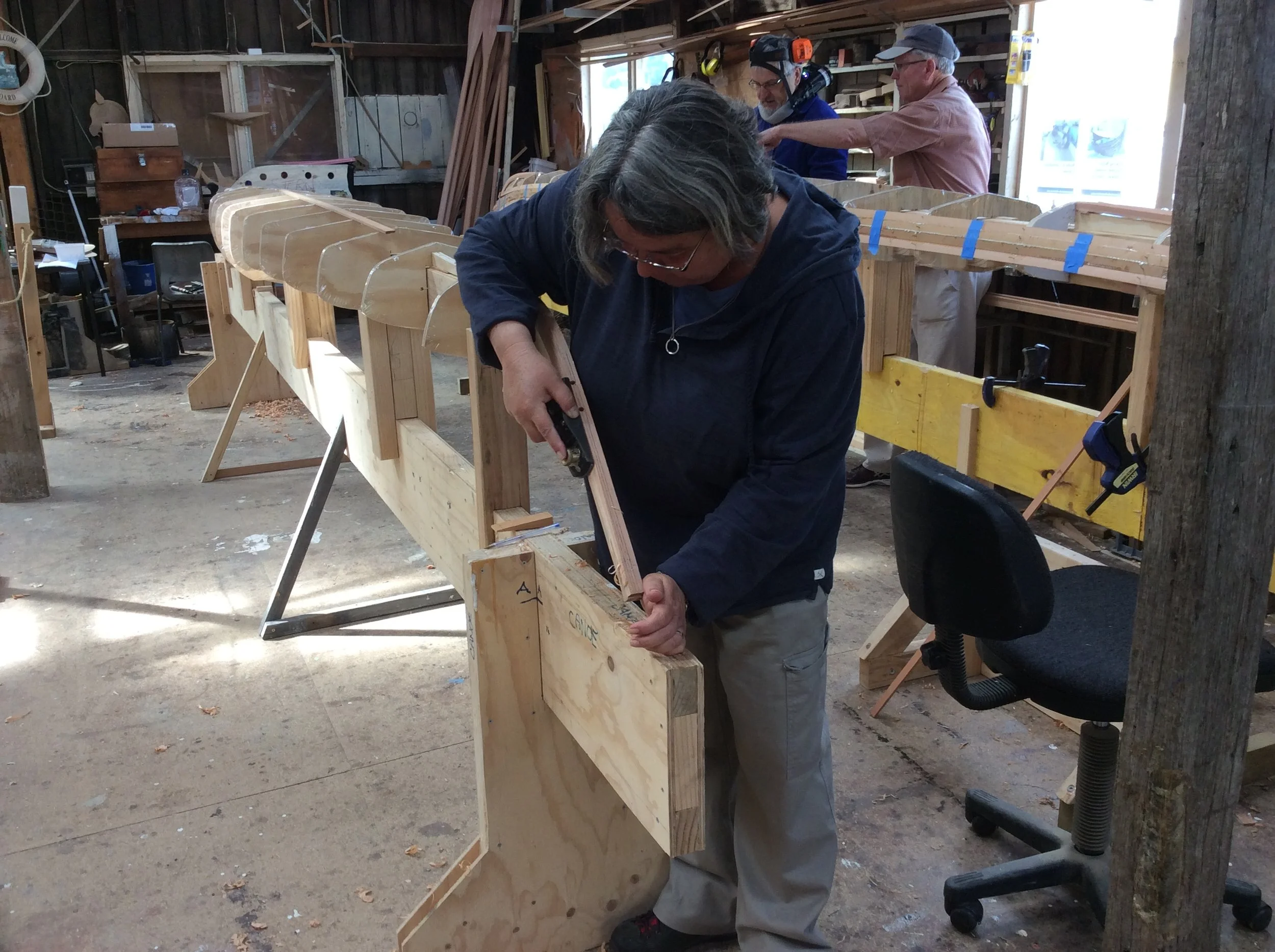 Lara shaping the stem of her strip planked kayak